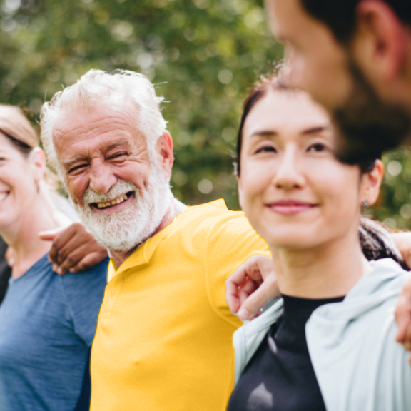 Group of six people of all ages smiling and laughing with each other