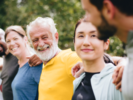 Group of six people of all ages smiling and laughing with each other