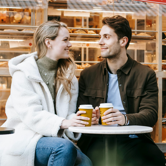 Couple discussing debt and finances on a coffee date