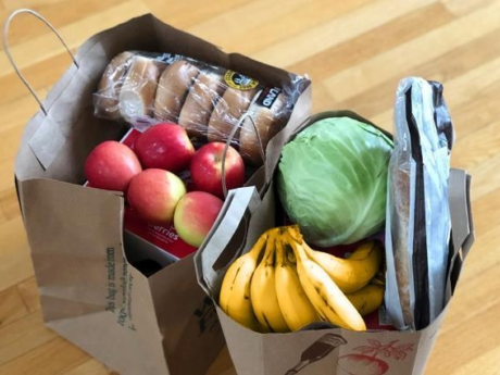 Two small paper bags filled with groceries representing the rising cost of living in Canada