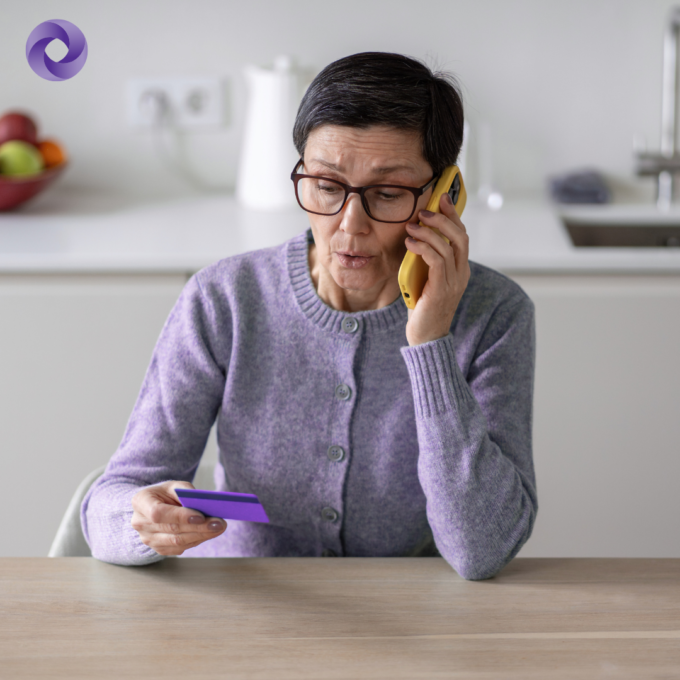 Woman on the phone holding a credit card