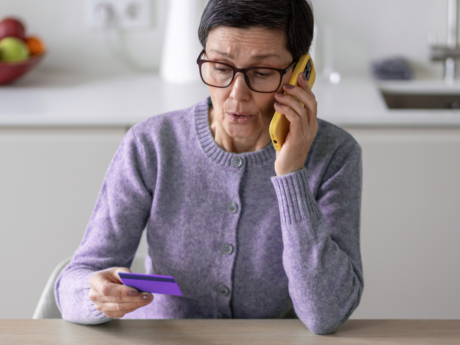 Woman on the phone holding a credit card
