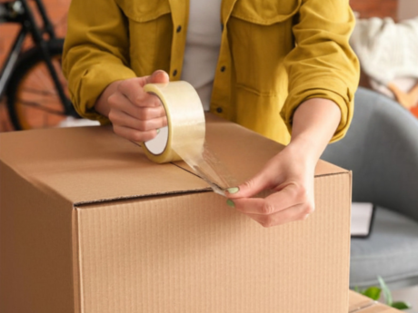 Person packing a box for moving